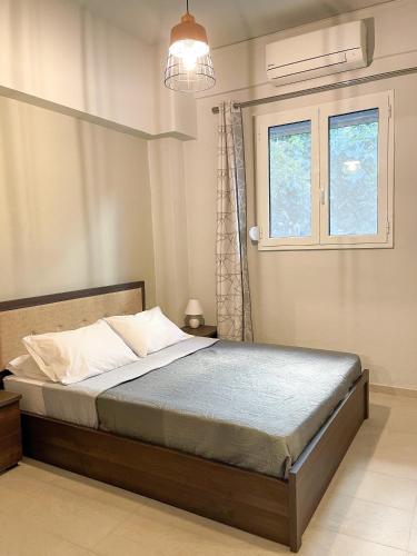 a bedroom with a large bed with a window at Central neighborhood house in Stalida