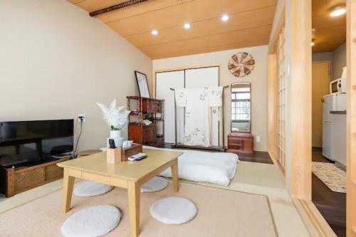 a living room with a table and a kitchen at Minami Toji---JP Style Guesthouse in Kyoto in Kyoto