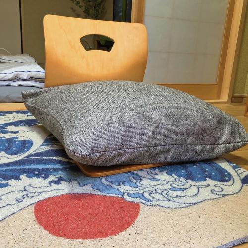 a pillow sitting on top of a rug on a floor at Minami Toji---JP Style Guesthouse in Kyoto in Kyoto
