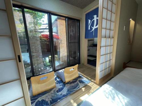 a bedroom with a bed and a window with a view at Minami Toji---JP Style Guesthouse in Kyoto in Kyoto
