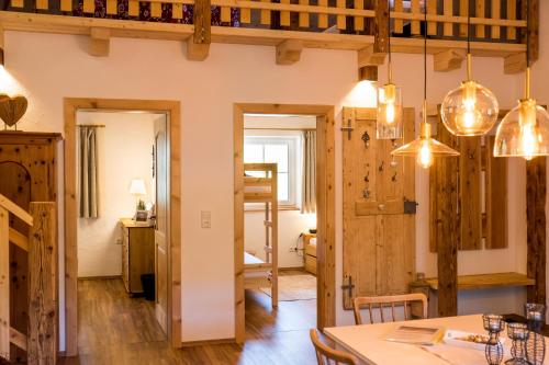 a dining room with a table and a ladder at Bergheimat in Bad Goisern