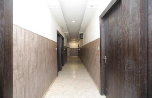 a hallway with wooden walls and a hallway with doors at Hotel Royal Galaxy in Faithfulganj