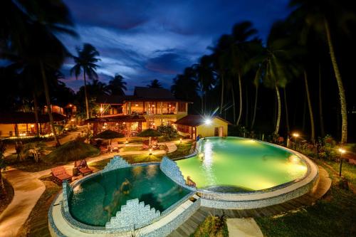 an overhead view of a swimming pool at night at Silver Sand Beach Resort Neil in Neil Island