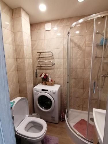 uma casa de banho com um WC e uma máquina de lavar roupa. em One bedroom apartment em Jūrmala