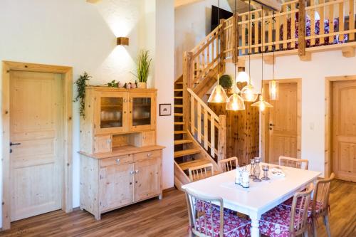 a dining room with a table and a staircase at Bergheimat in Bad Goisern