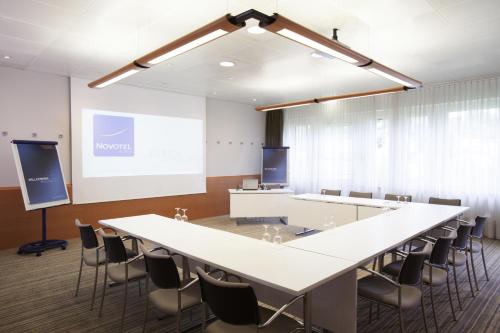a conference room with a large white table and chairs at Novotel Zürich Airport Messe - newly renovated in Glattbrugg