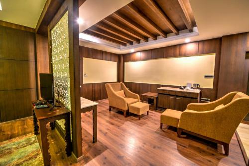 a waiting room with two chairs and a table at Silver Sand Sentinel in Port Blair