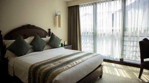a bedroom with a large bed and a large window at Superior Room Space Available in Accra