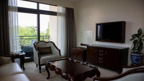 a living room with a couch and a tv at Superior Room Space Available in Accra