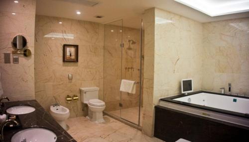 a bathroom with a tub and a toilet and a shower at Superior Room Space Available in Accra