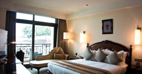 a hotel room with a bed and a balcony at Superior Room Space Available in Accra
