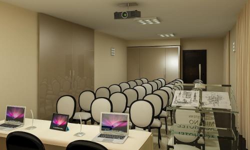 a room with tables and chairs with laptops on them at Best Western Premier Milano Palace Hotel in Modena