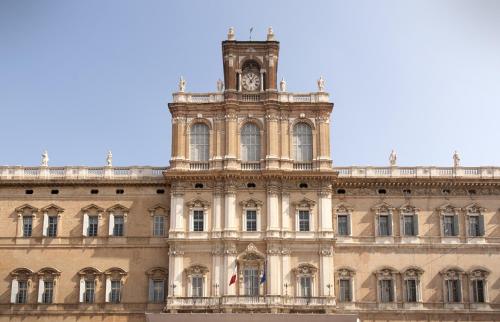 a building with a clock tower on top of it at Best Western Premier Milano Palace Hotel in Modena