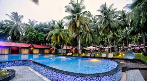 a swimming pool with a pool table and chairs at Silver Sand Beach Resort Havelock in Havelock Island