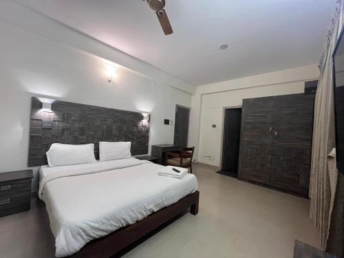 um quarto com uma cama grande num quarto em PPH Living Athithi Inn Corporate Stay em Coimbatore