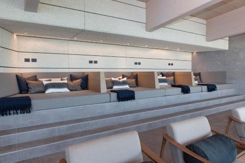 a waiting room with couches and chairs in a building at Serviced Apartments by Hotel de Charme Laveno in Laveno