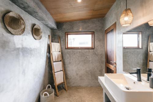 a bathroom with a sink and a mirror at Kano Canggu Loft in Canggu