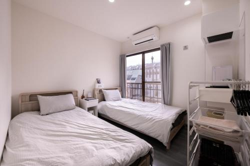 Postel nebo postele na pokoji v ubytování ZAITO Tokyo Skytree-Yokokawa II Studio 天空树旁舒适型民宿-宅东横II号店