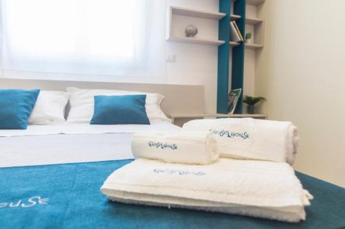 a room with two beds with towels on the floor at GIOSAHOUSE in Uggiano la Chiesa