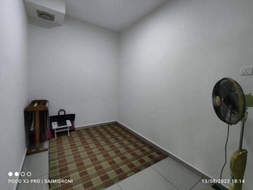 a room with a fan in the corner of a room at Sehmi's Homestay, Pagoh, Muar in Pagoh