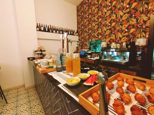 a kitchen with a buffet with food and drinks at Hotel Matilde by gaiarooms in Salamanca