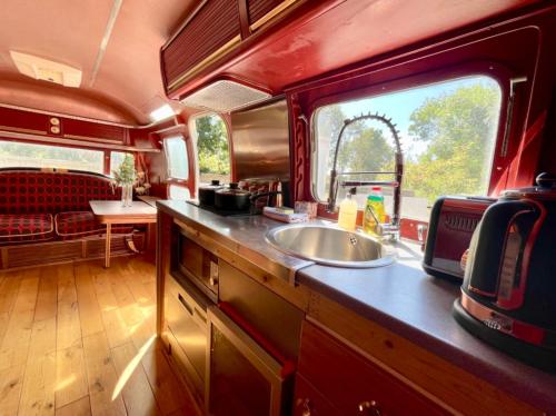 a kitchen with a sink in the middle of a train at Airstream at Hardham West Sussex Sleeps 4 in Pulborough