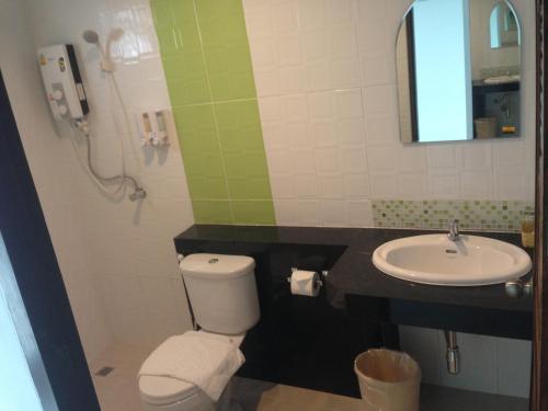 a bathroom with a toilet and a sink at Praiyanan Place Hotel in Maha Sarakham
