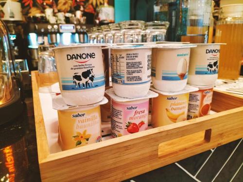 a bunch of containers of food sitting on a shelf at Hosteria Sara by gaiarooms in Salamanca