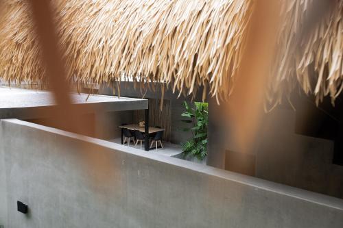 a room with a table and a straw roof at Panorama Villas El Nido in El Nido