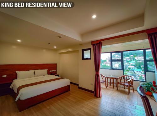 a bedroom with a bed and a table and chairs at 456 Hotel in Baguio