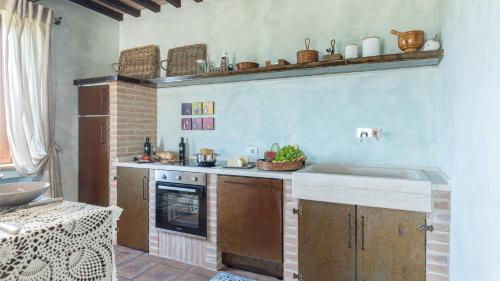 a kitchen with a sink and a stove at LE RESIDENZE DEI POTTI 12, Emma Villas in Collazzone
