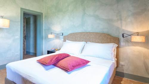 a bedroom with a large bed with two pillows on it at LE RESIDENZE DEI POTTI 12, Emma Villas in Collazzone