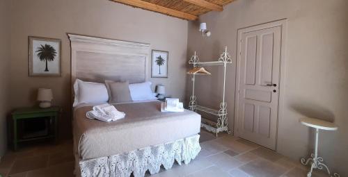 a bedroom with a bed in a room with a door at RoccaSeta in Scicli