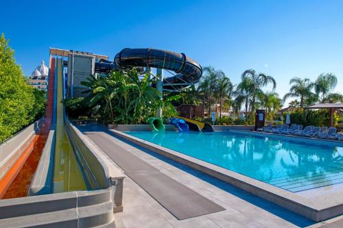 a pool at a resort with a slide at Adalya Elite Lara Hotel - Ultra All Inclusive in Lara