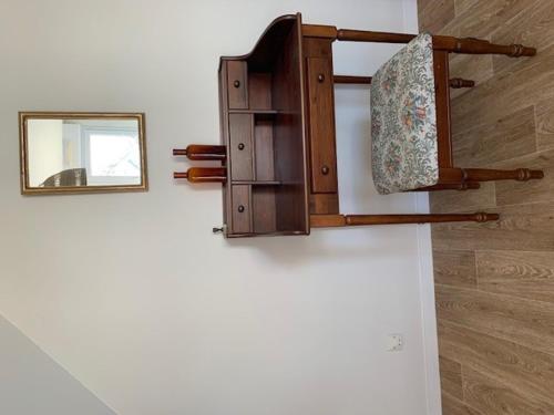 a mirror hanging on a wall next to a wall at La villa Noukey à 150m de la plage et des cabines in Gouville-sur-Mer