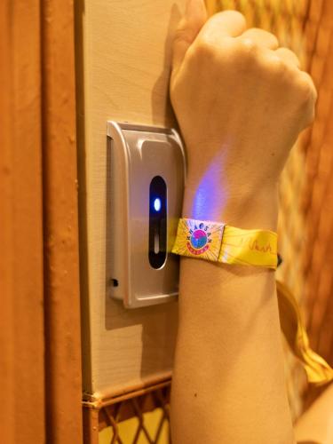 a person is reaching for a light on a refrigerator at Khao San Social Capsule Hostel in Bangkok