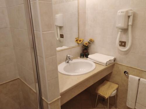 a bathroom with a sink and a shower at Villa Torretta in Varenna