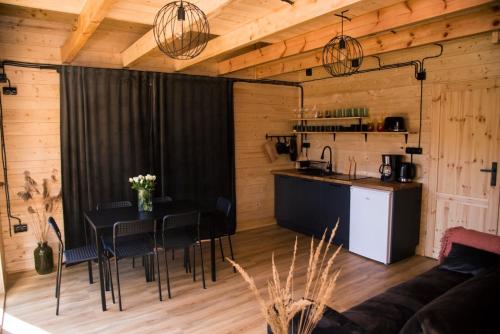 a kitchen and dining room with a table in a room at Sominkowe Wzgórze in Sominy