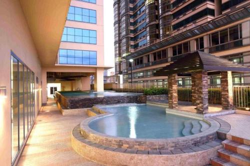 a pool in the middle of a building at Grand Riviera Suites Comfy Condo near US Embassy Manila Bay Roxas Blvd Ermita Manila in Manila