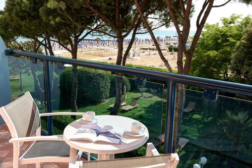 a table and chairs on a balcony with a view of the beach at Park Hotel Brasilia in Lido di Jesolo