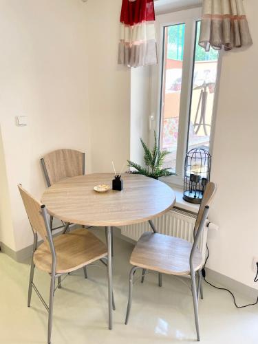 a table and chairs in a room with a window at Penzion Villa Amélie in Mladá Boleslav