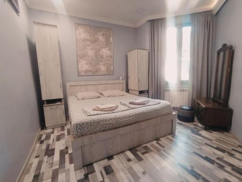 a bedroom with a large bed in a room at Guesthouse Kato in Tbilisi City