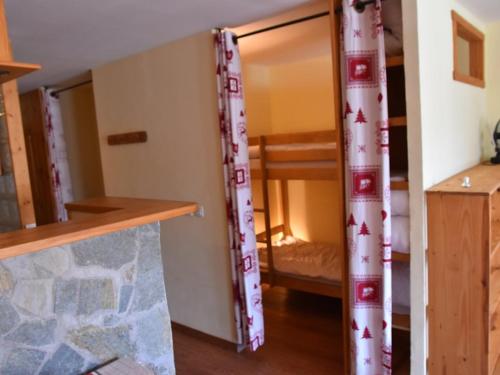 une chambre avec deux lits superposés et un bureau dans l'établissement Studio avec Parking, Balcon Sud-Ouest et Équipements Complets - FR-1-266-193, à Montgenèvre