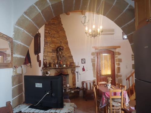 a living room with an archway and a table with a television at Traditional Luxury Villa in Fres in Frés