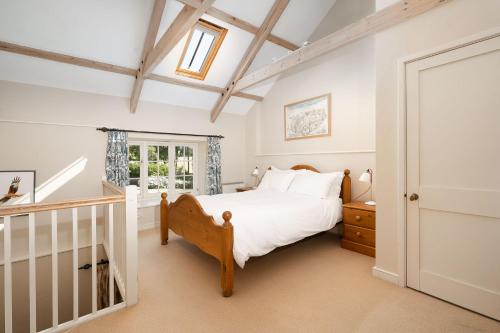 a bedroom with a bed and a window at Moon Cottage in Newquay