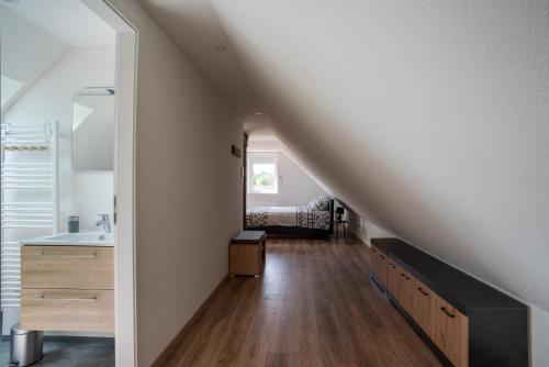 a hallway with a staircase leading to a bathroom with a sink at Gemütlich 7 - Appartement cosy climatisé in Wissembourg