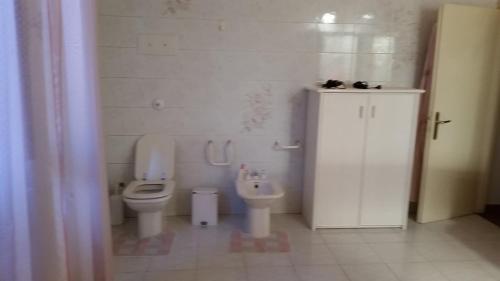 a white bathroom with a toilet and a bidet at Villa Storica Calderino in Monte San Pietro