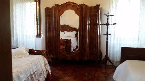 a bedroom with a large mirror and a bed at Villa Storica Calderino in Monte San Pietro