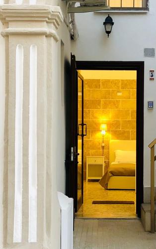a room with a door leading to a bedroom at Corte Gabellone - dimora storica in Nardò