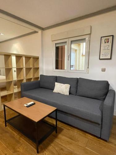 a living room with a couch and a coffee table at CHUECA Apartamentos Noxi in Madrid